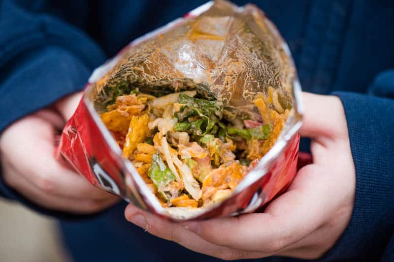 walking camping tacos in a small Nacho Cheese Doritos chip bag