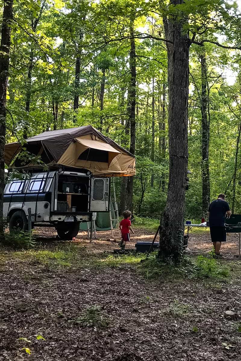 family in Ozark National Forest dispersed camping spot with rooftop tent and kitchen setup