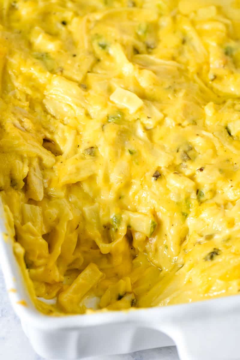 scooped cheesy turkey casserole in white baking dish