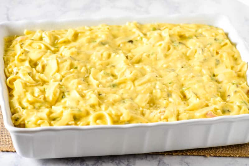 cheesy turkey tetrazzini in white baking dish before baking