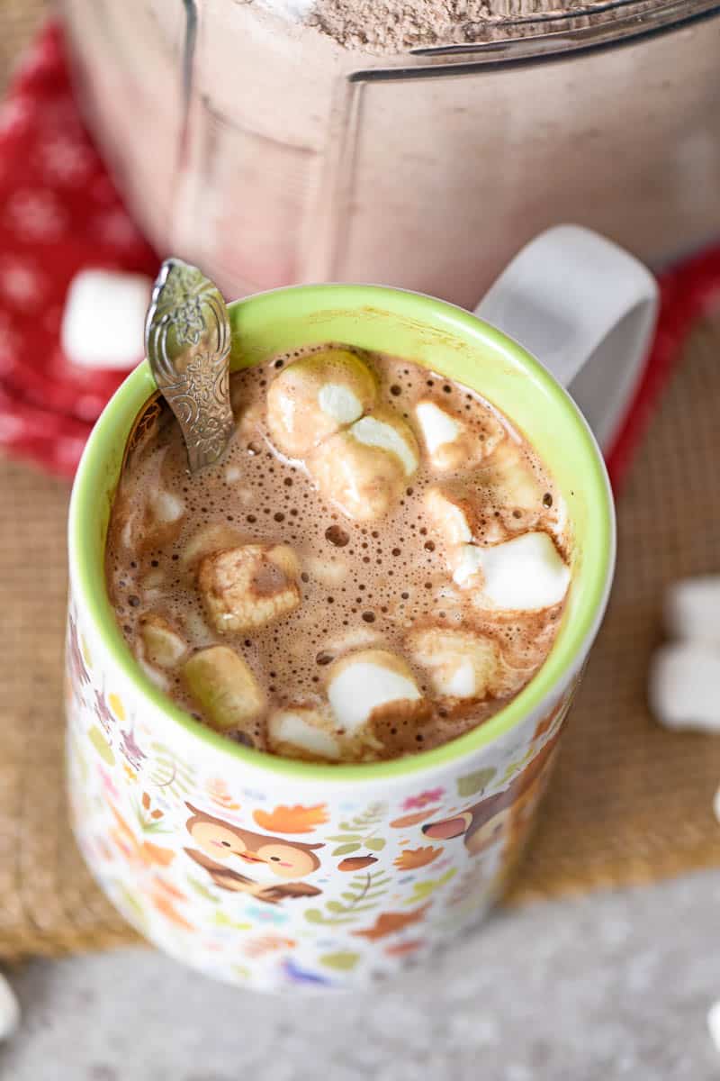 homemade hot chocolate with mini marshmallows and a spoon in a Disney Bambi mug