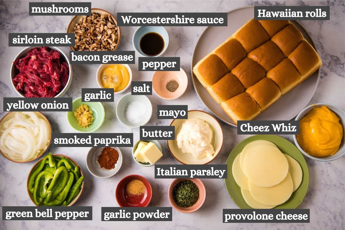 Philly cheesesteak sliders ingredients on white marble countertop