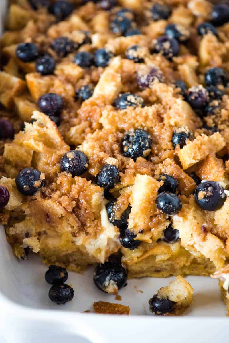 sliced blueberry cream cheese French toast casserole in white baking dish