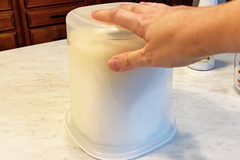 natural cleaning wipes sitting upside down in a sealable container on white countertop 'til liquid cleaning mixture soaks into the paper towels