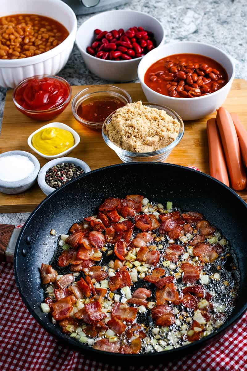 cooked and crumbled bacon and chopped onion in large skillet 
