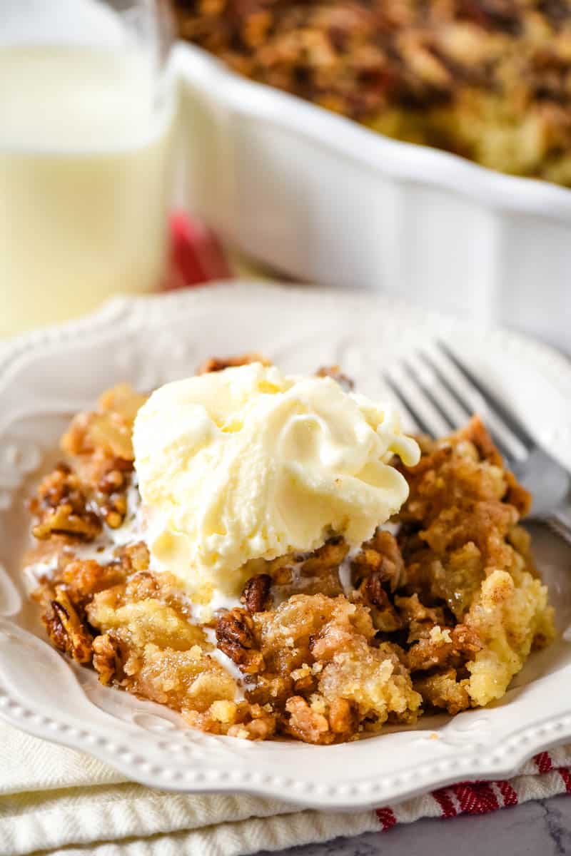 caramel apple dump cake on white plate with fork
