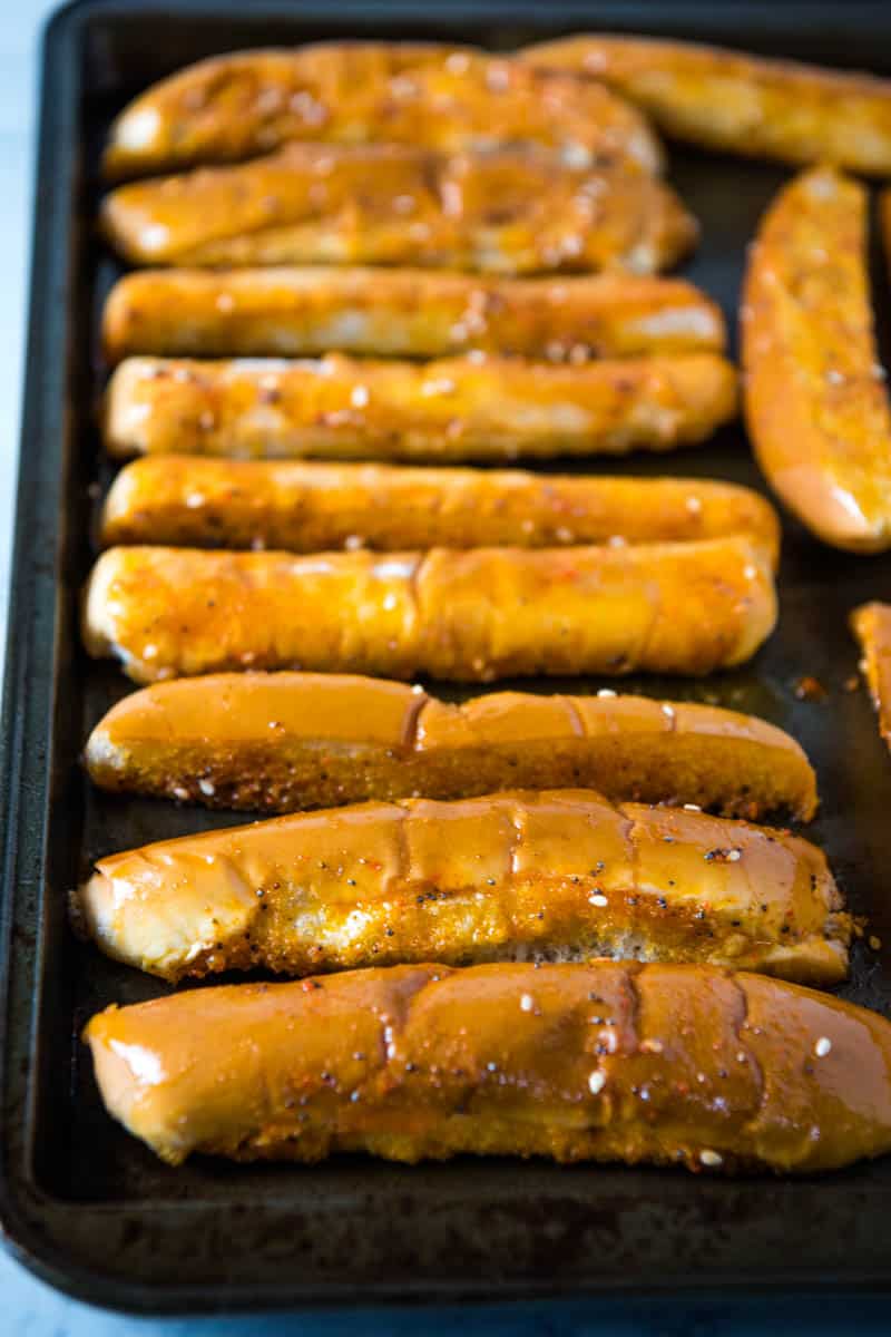 baked hot dog bun bread sticks on baking sheet