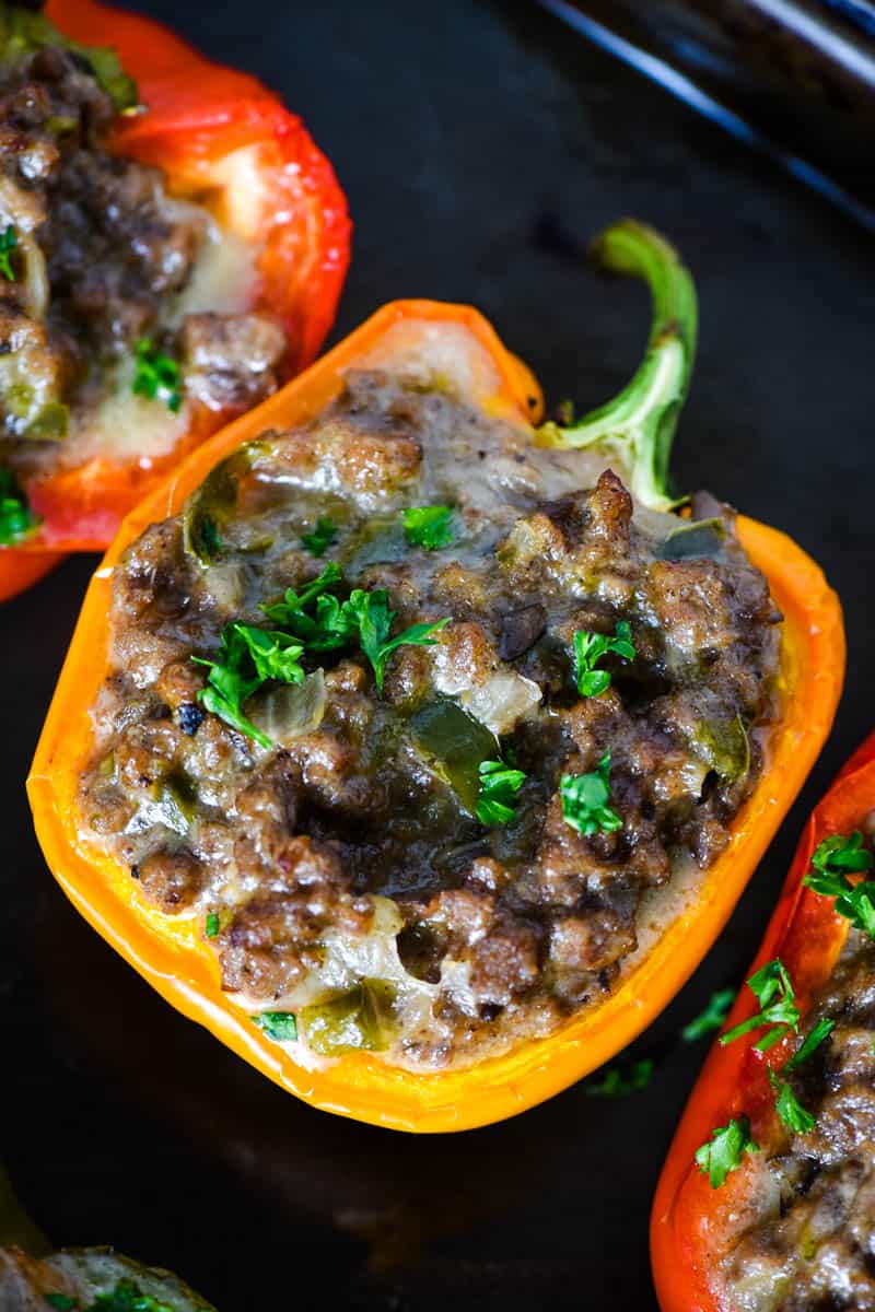 orange Philly cheesesteak stuffed pepper on baking sheet