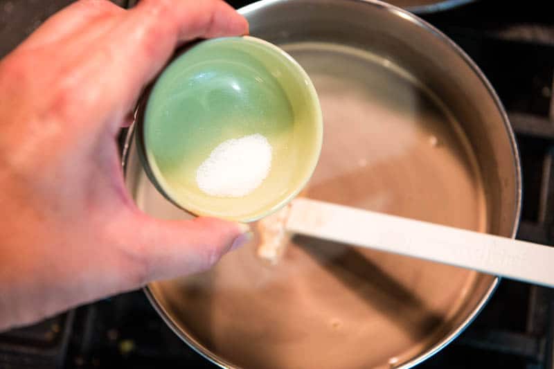adding salt to saucepan while making hot chocolate with chocolate chips