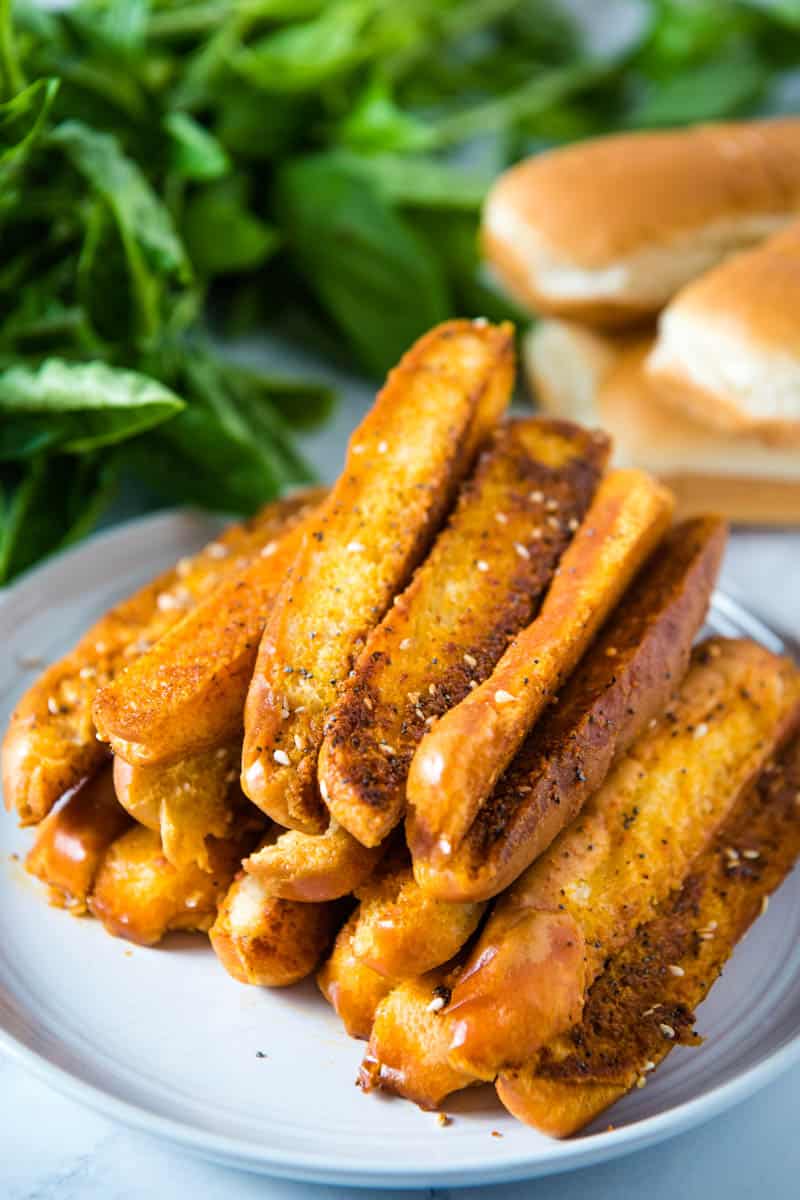 pile of quick garlic breadsticks on gray plate