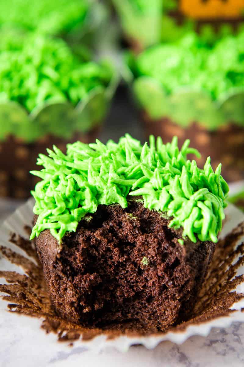 bite out of chocolate Minecraft cupcake sitting on white cupcake liner