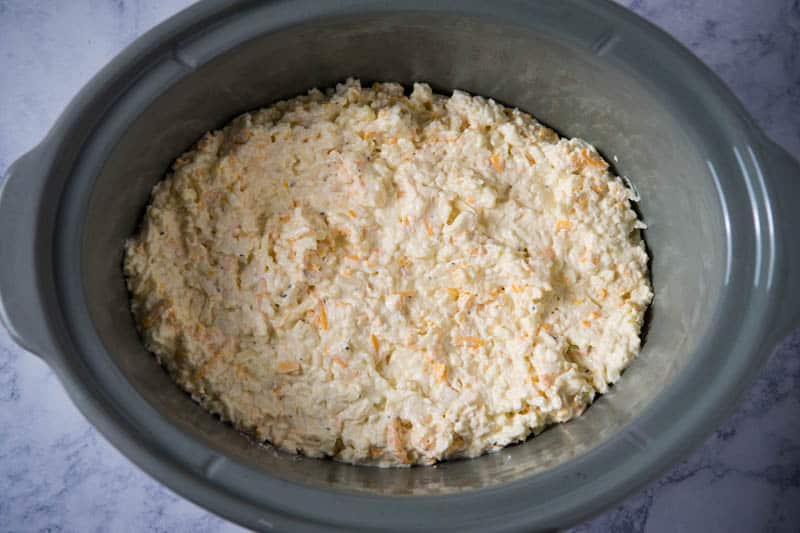 mixture for slow cooker hash brown casserole spread in gray slow cooker