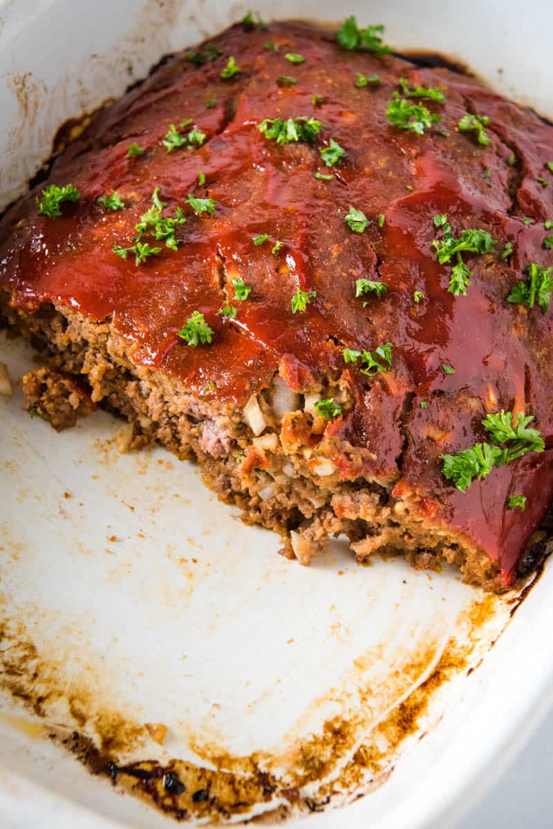 traditional meatloaf with bread crumbs, sliced in white baking dish