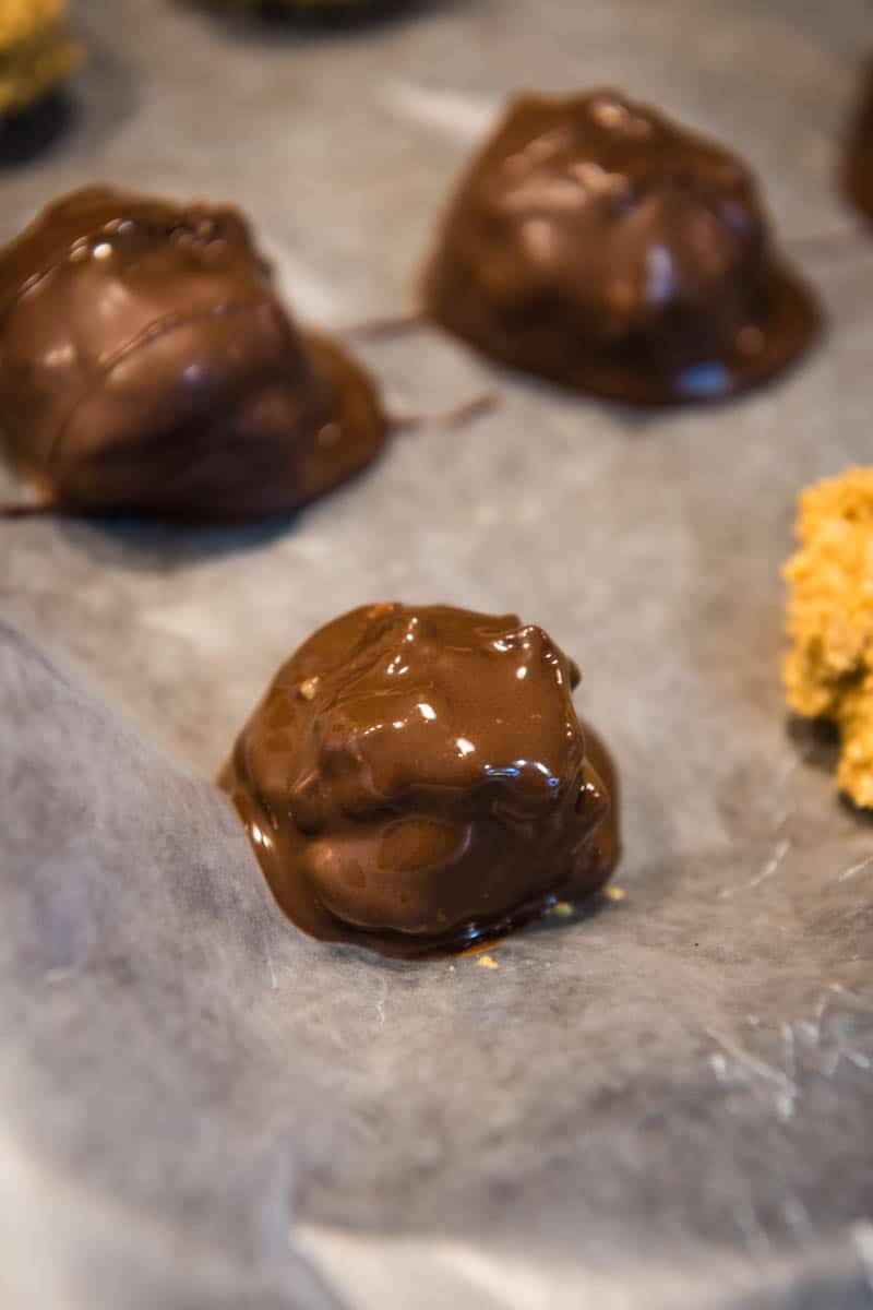 just dipped chocolate crispy balls on wax paper lined baking sheet