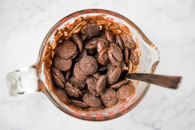 melting dark chocolate wafers in glass Pyrex measuring cup