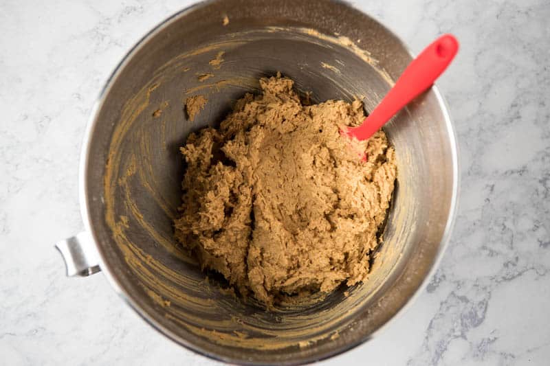 rice crispy peanut butter balls dough with red spatula in large bowl