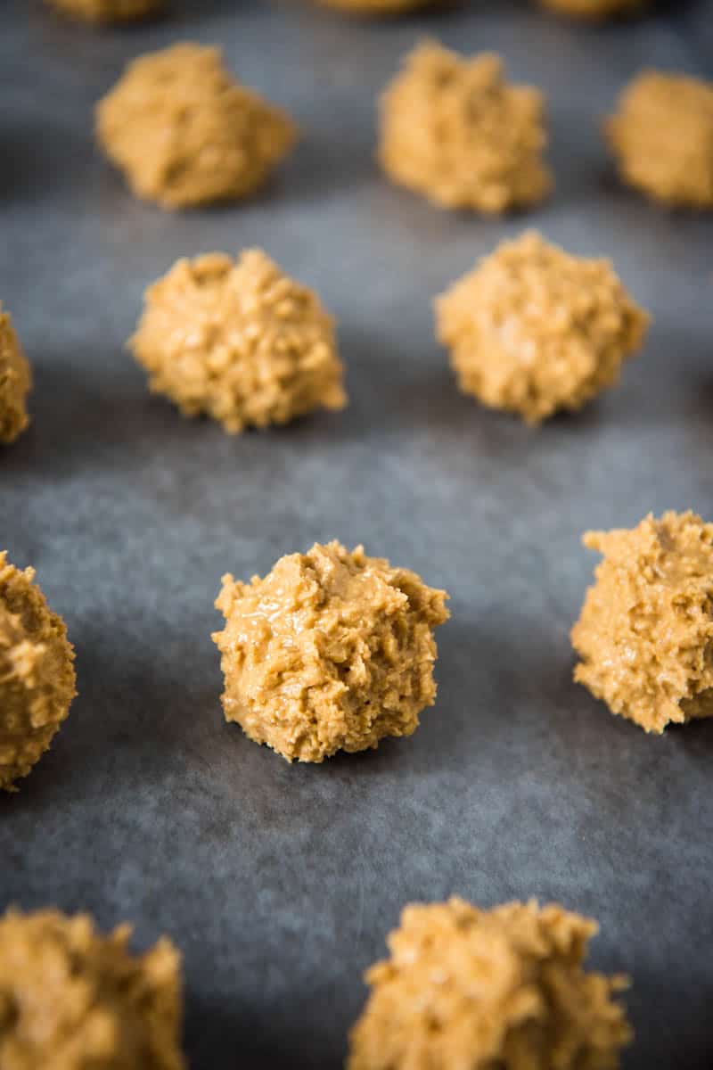 rolled crispy peanut butter balls on wax paper lined baking sheet
