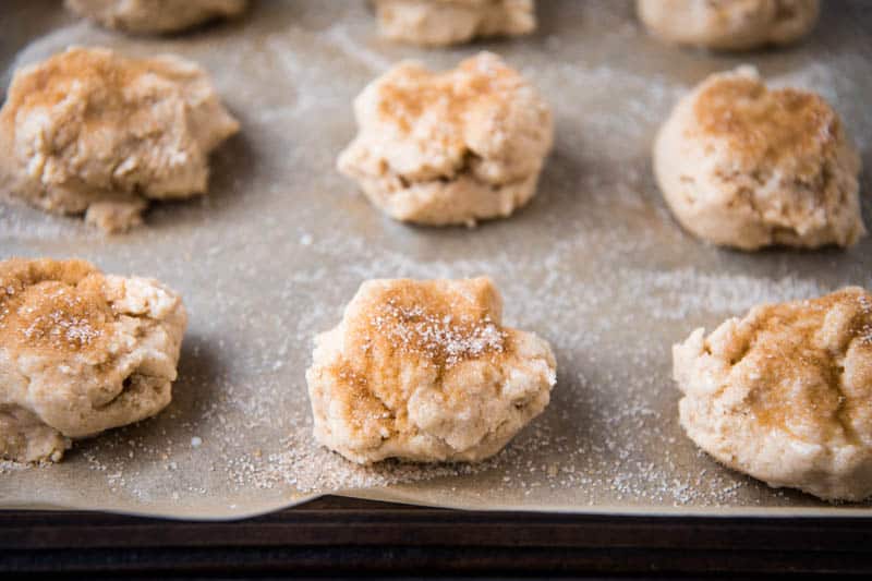 Bisquick drop scones sprinkled with cinnamon sugar on parchment paper lined baking sheet