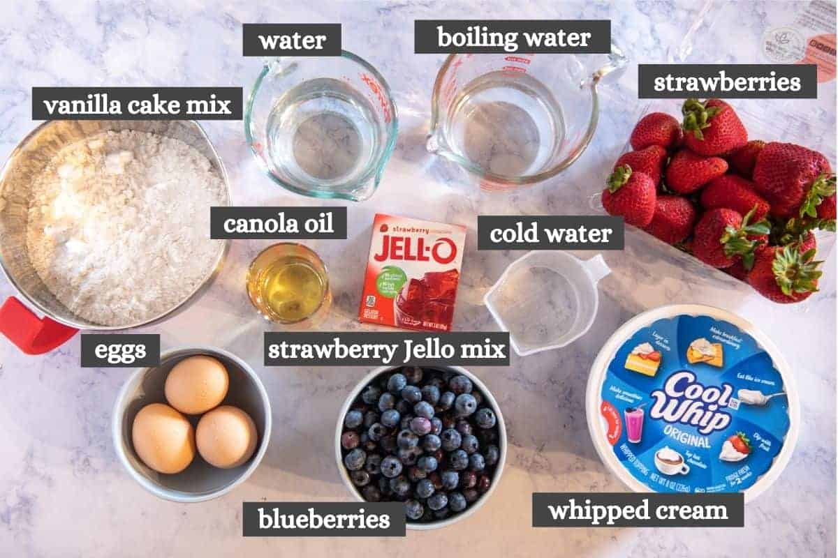 American flag cake ingredients on white marble countertop