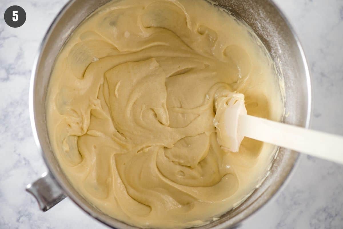 cinnamon streusel coffee cake batter in KitchenAid mixing bowl with white rubber spatula