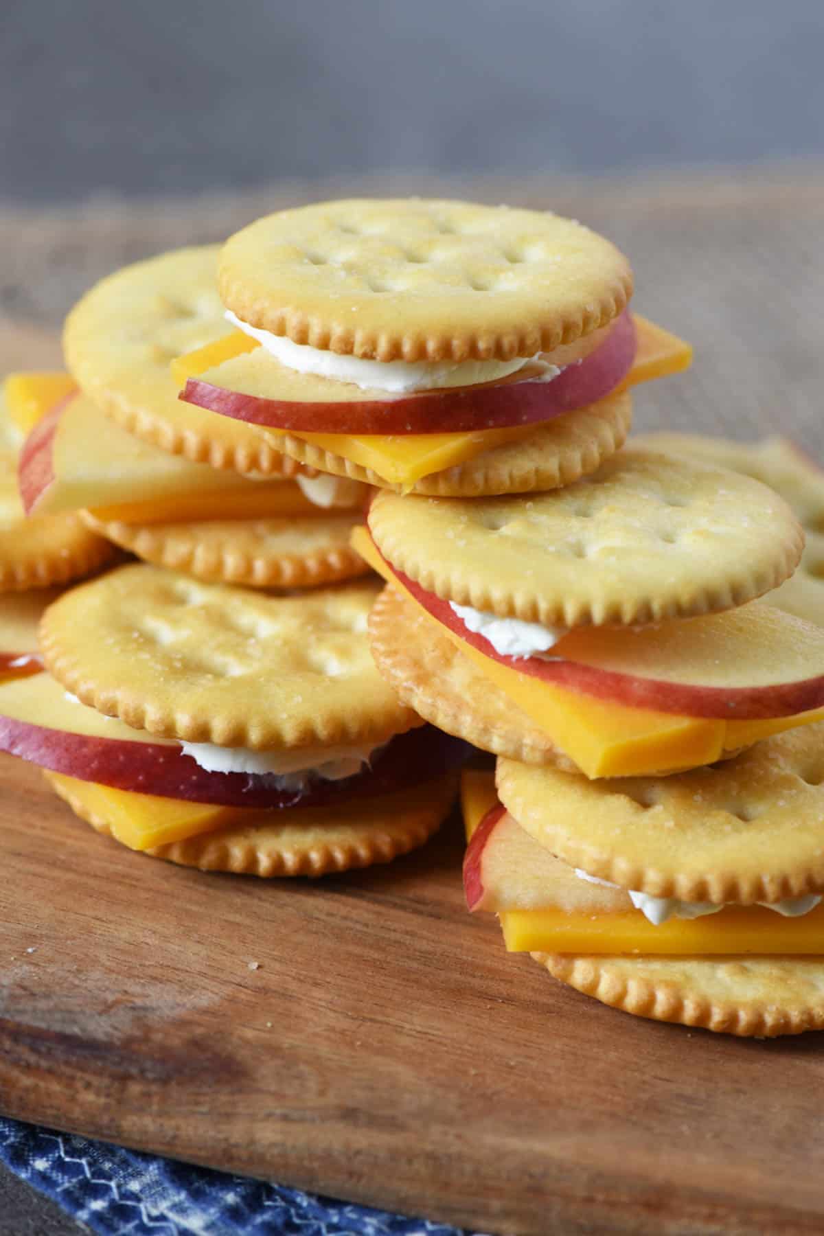 cheddar apple crackers on wooden cutting board