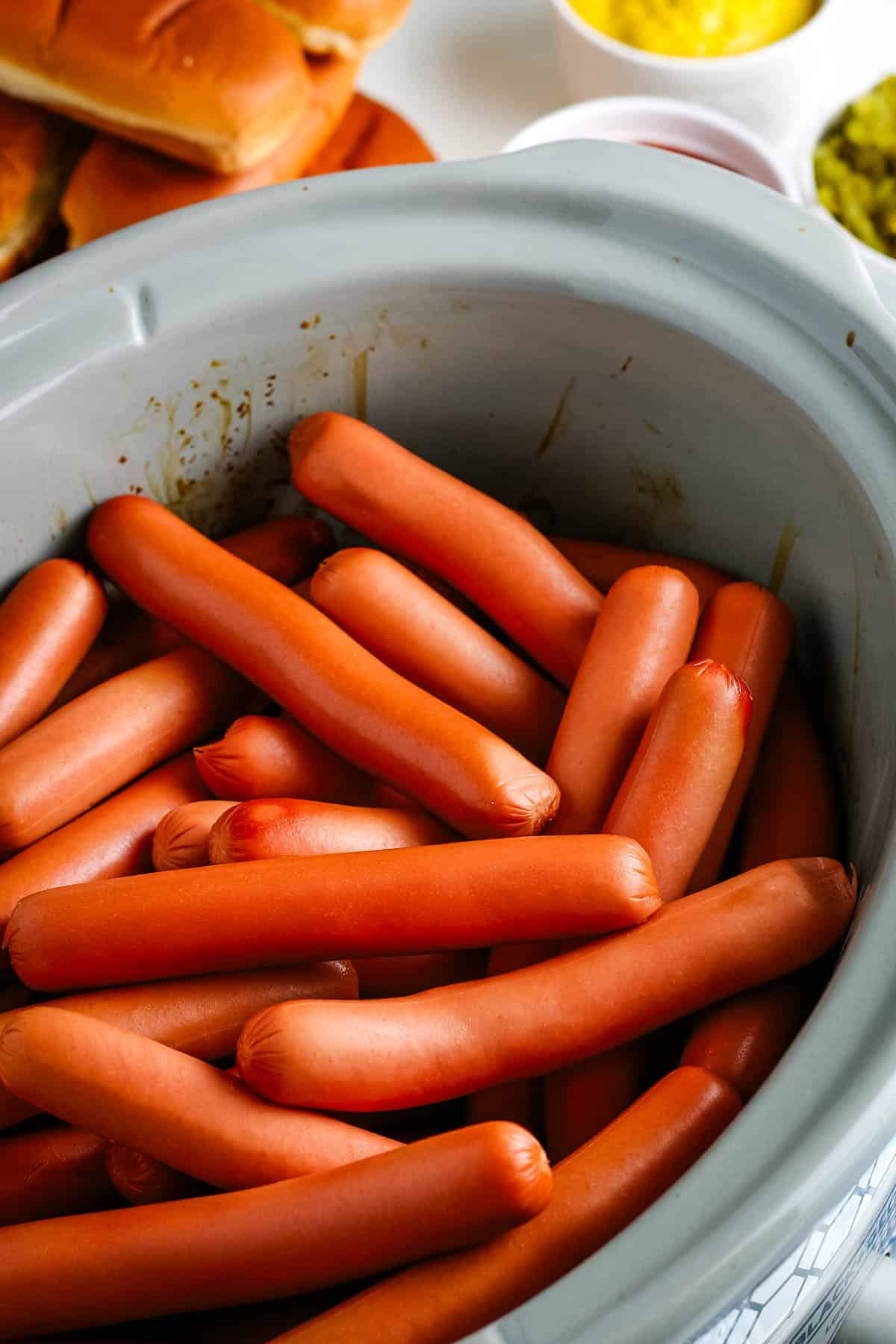 CrockPot hot dogs cooked in a gray slow cooker