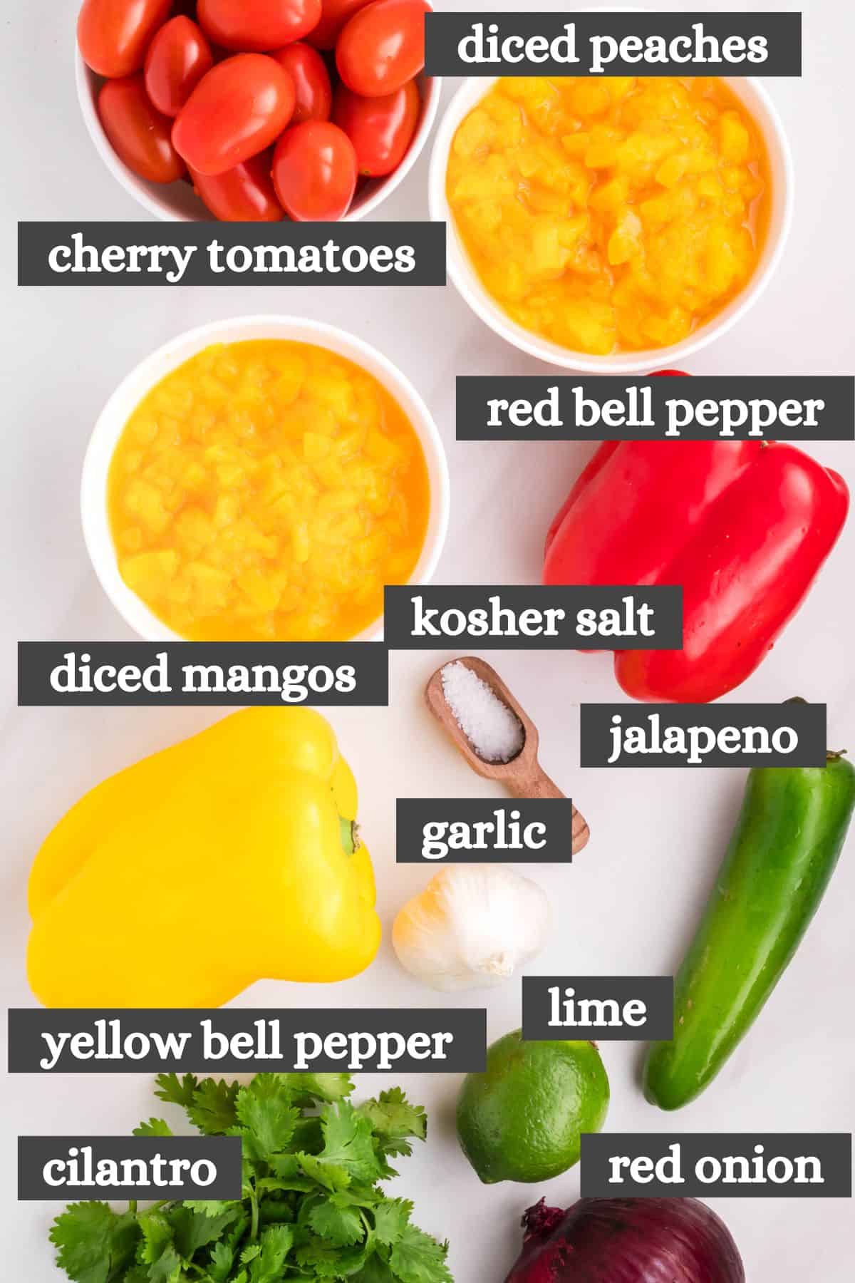 peach mango salsa ingredients lined out on a white countertop