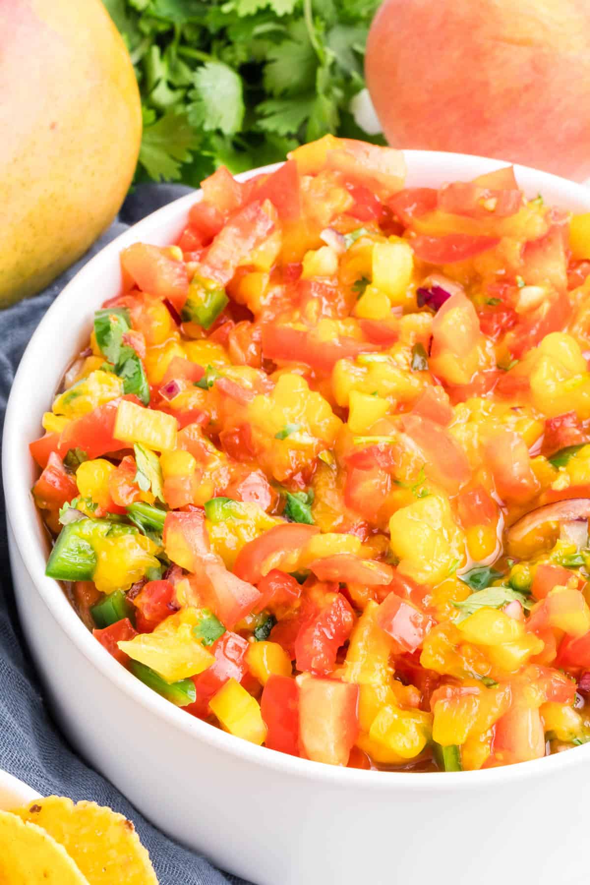 mango peach salsa in a medium white serving bowl