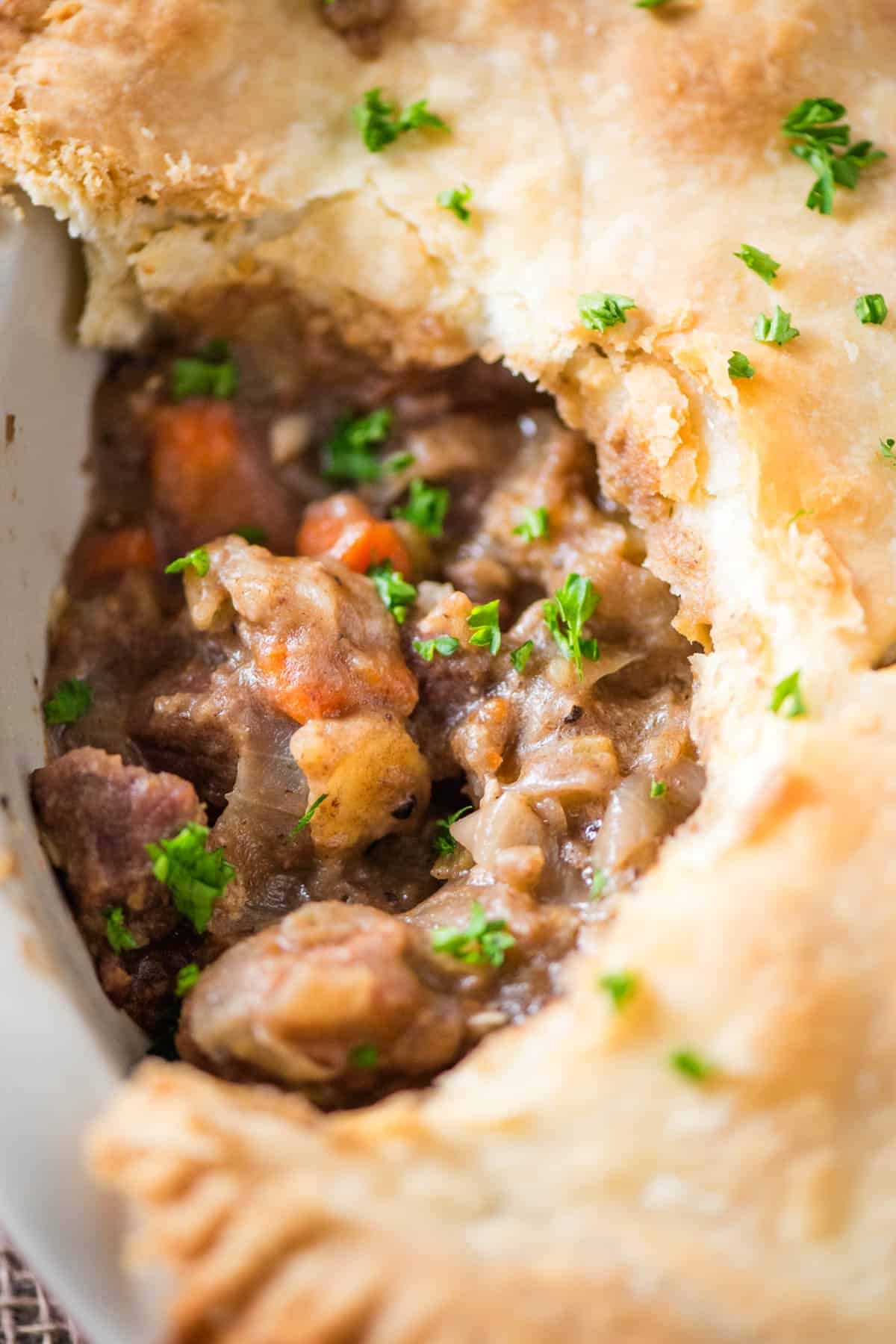 freshly baked steak pie in a large white pie plate