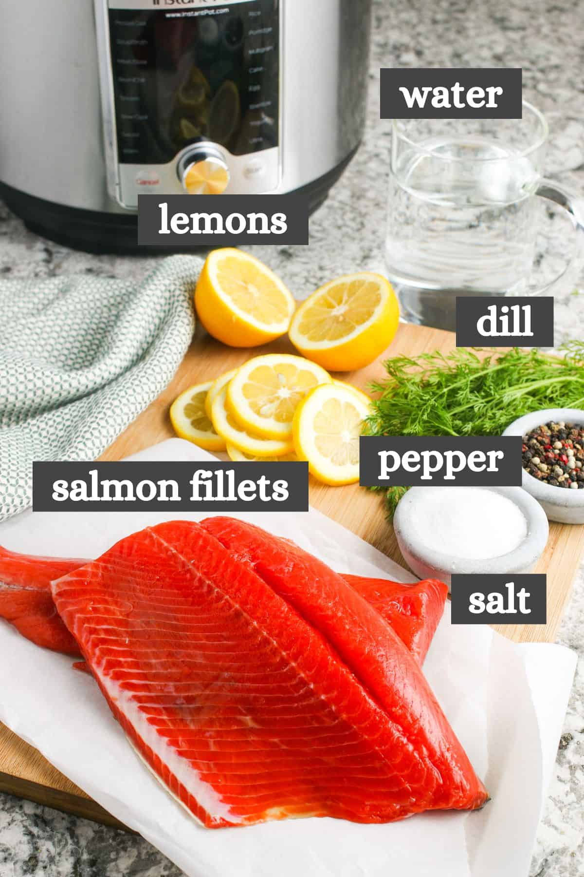 Instant Pot salmon ingredients lined out on a large wooden cutting board