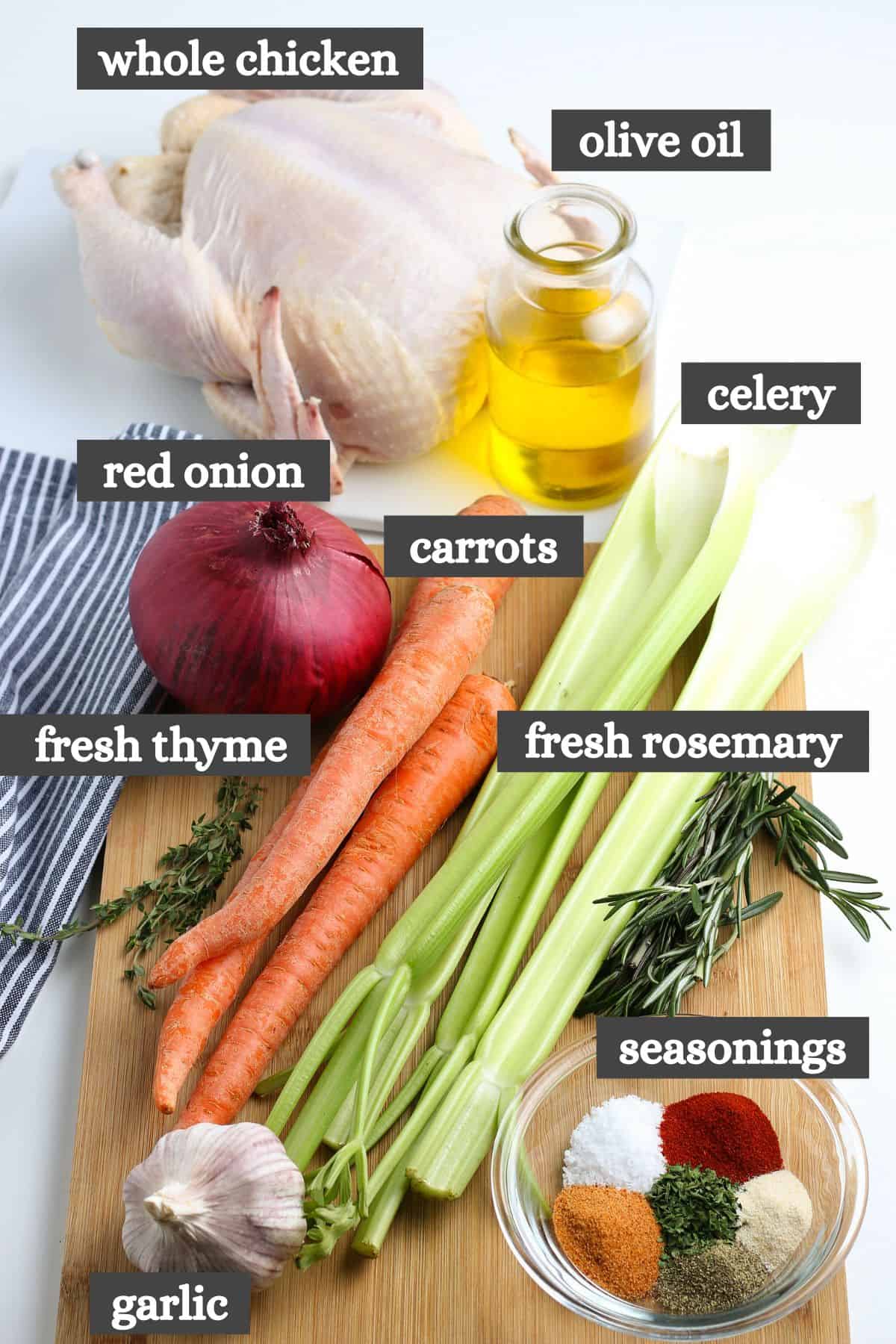 slow cooker whole chicken ingredients lined out on a large wooden cutting board