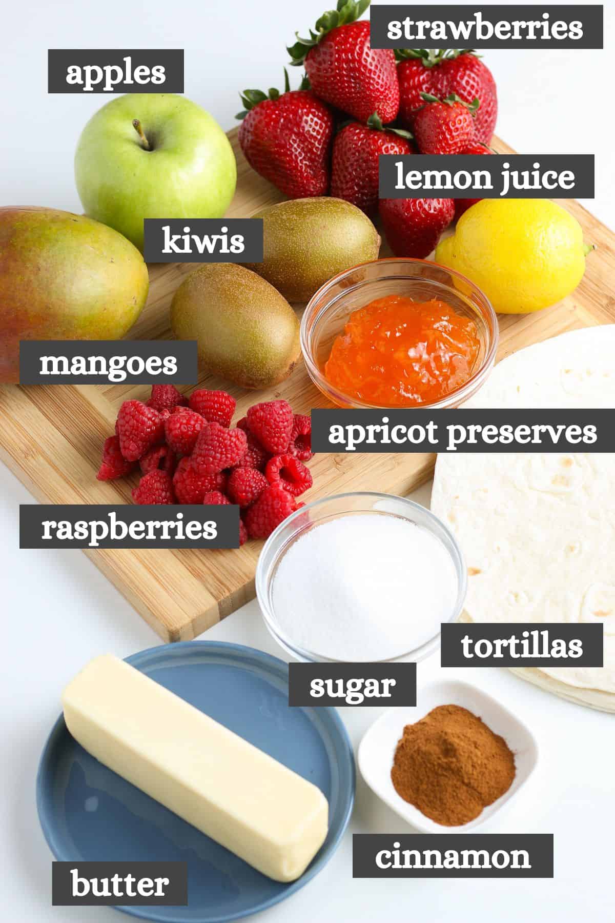 fruit salsa recipe ingredients lined out on a large wooden cutting board
